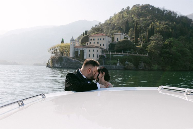 A couple on the boat, with the villa behind