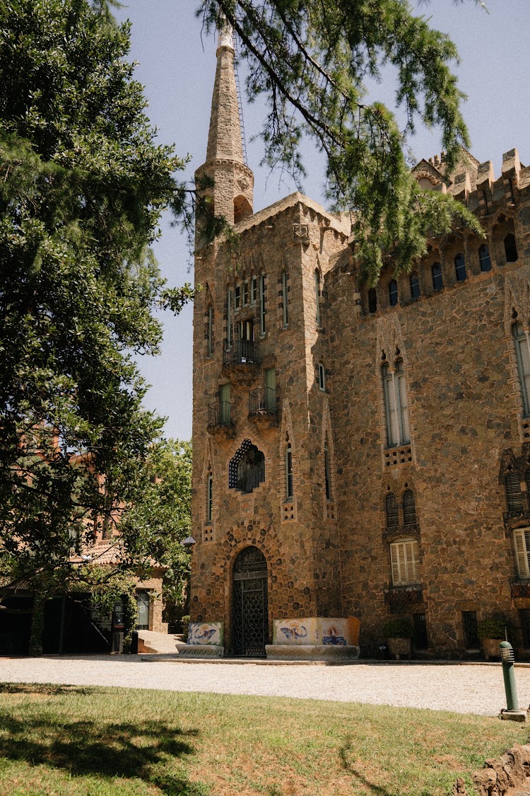 Bellesguard Tower, a Gaudí building in Barcelona, with its stone facade, pointed spire and arched entrance door