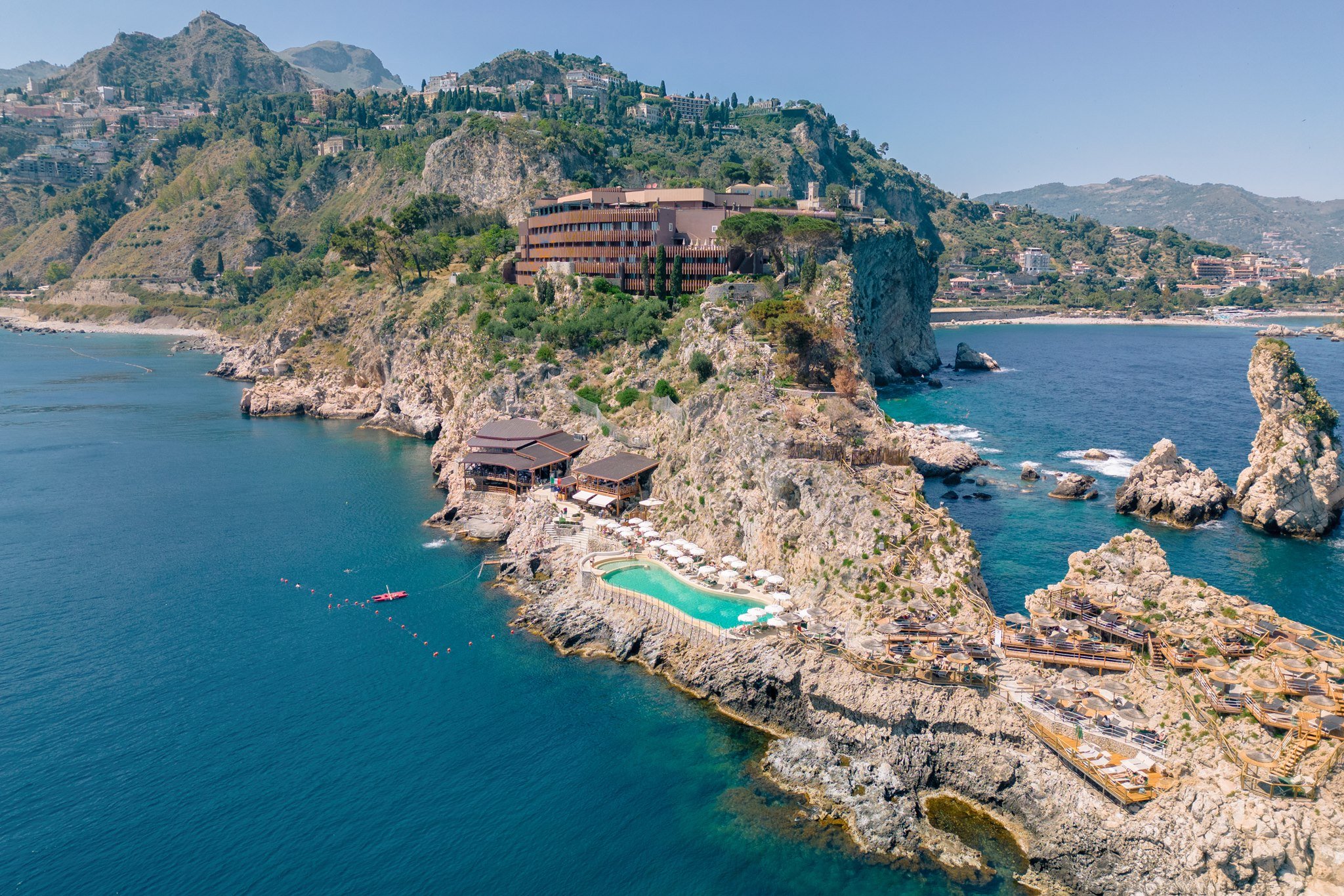 UNA Hotels Capotaormina on the cliffs of Capo Taormina, with its saltwater pool above the sea