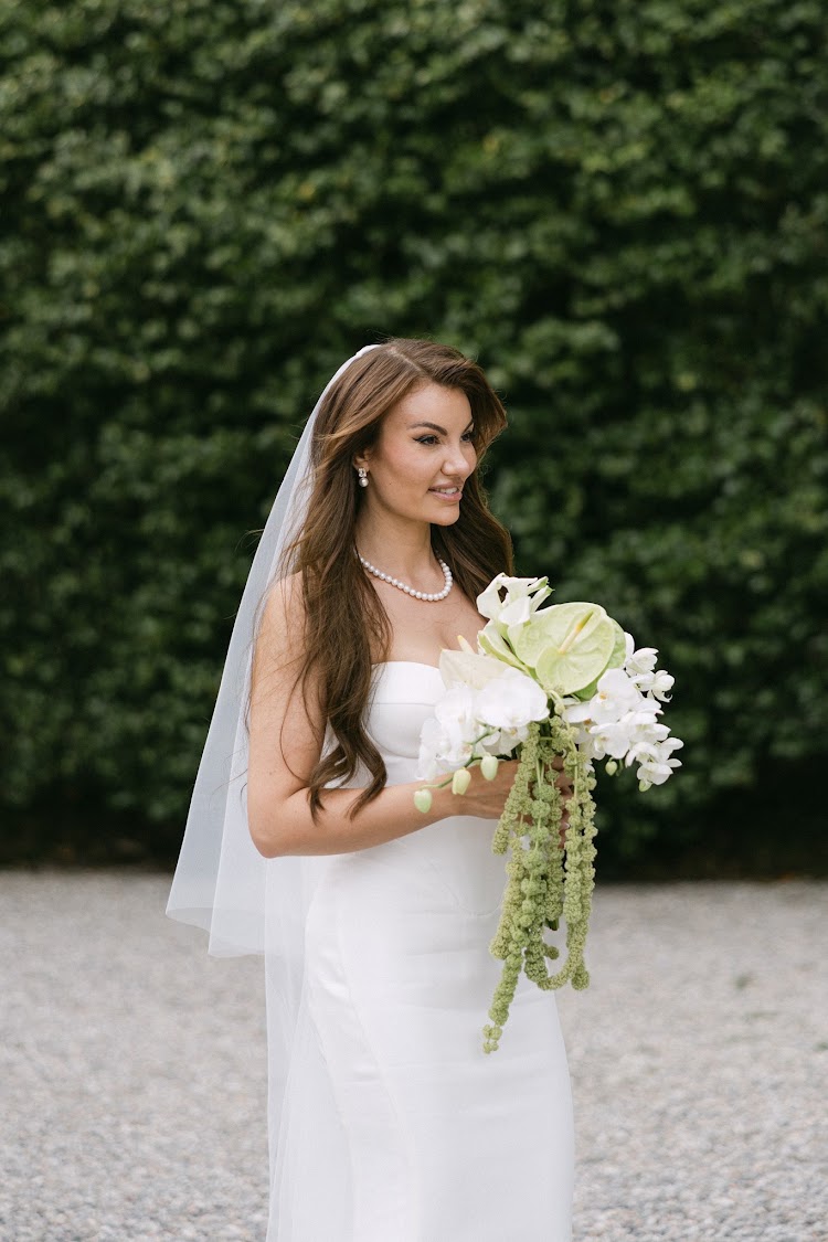 A bride with her bouquet in the gardens