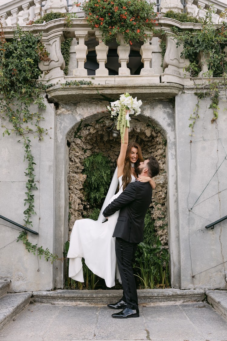 Celebrating under a stone arch in the gardens
