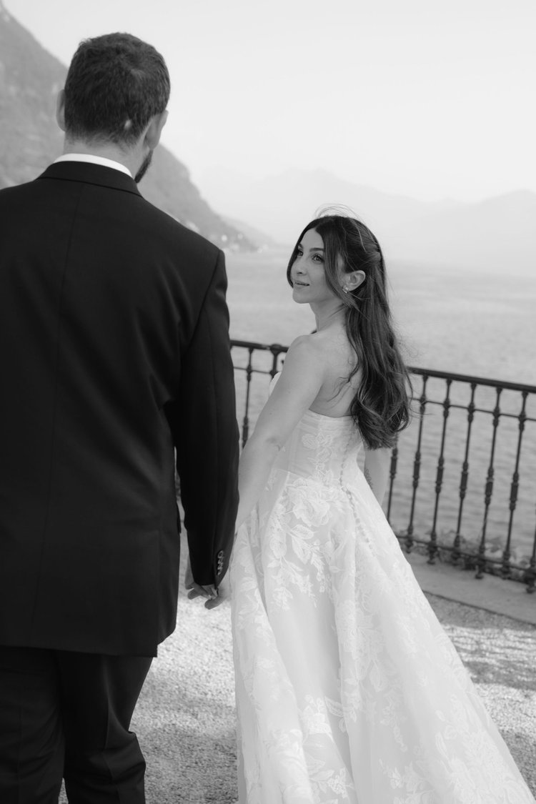 A couple at the railing above the lake