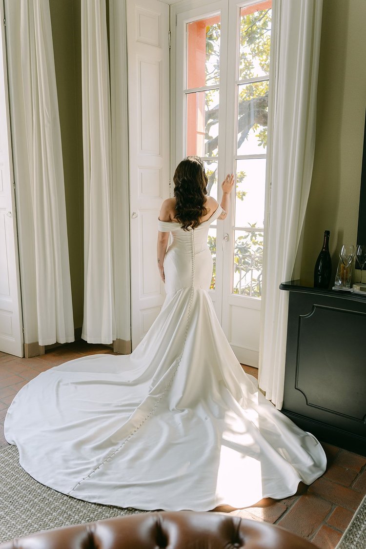 A bride at the window of her suite
