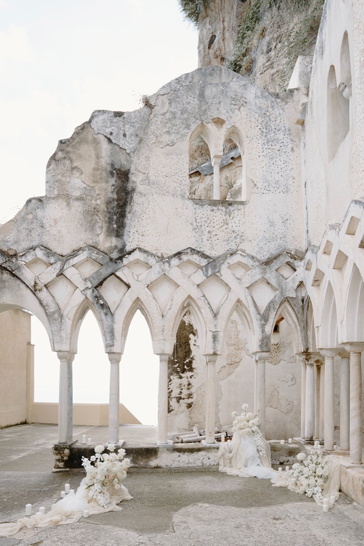 The cloister arches dressed with white flowers for a ceremony