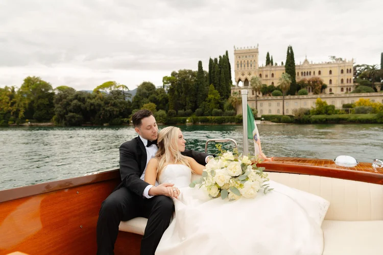 A couple on a private boat leaving Isola del Garda