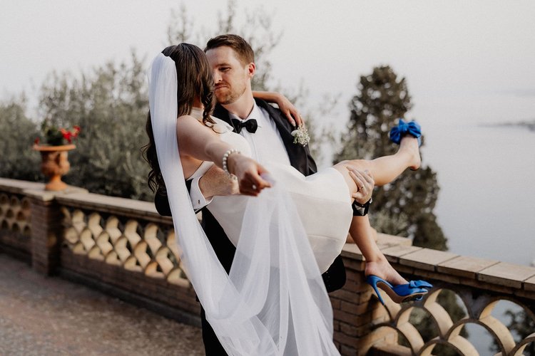 A groom lifting his bride in a romantic moment during their elopement in Sicily
