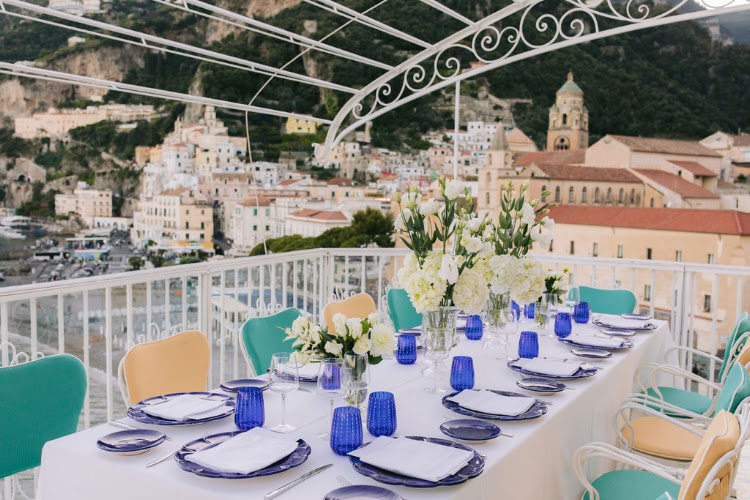 Elopement dinner table with blue glassware and white flowers on a terrace overlooking Amalfi, Hotel Marina Riviera on the Amalfi Coast