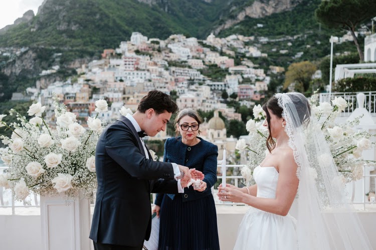 Exchanging rings on the terrace, with Positano behind