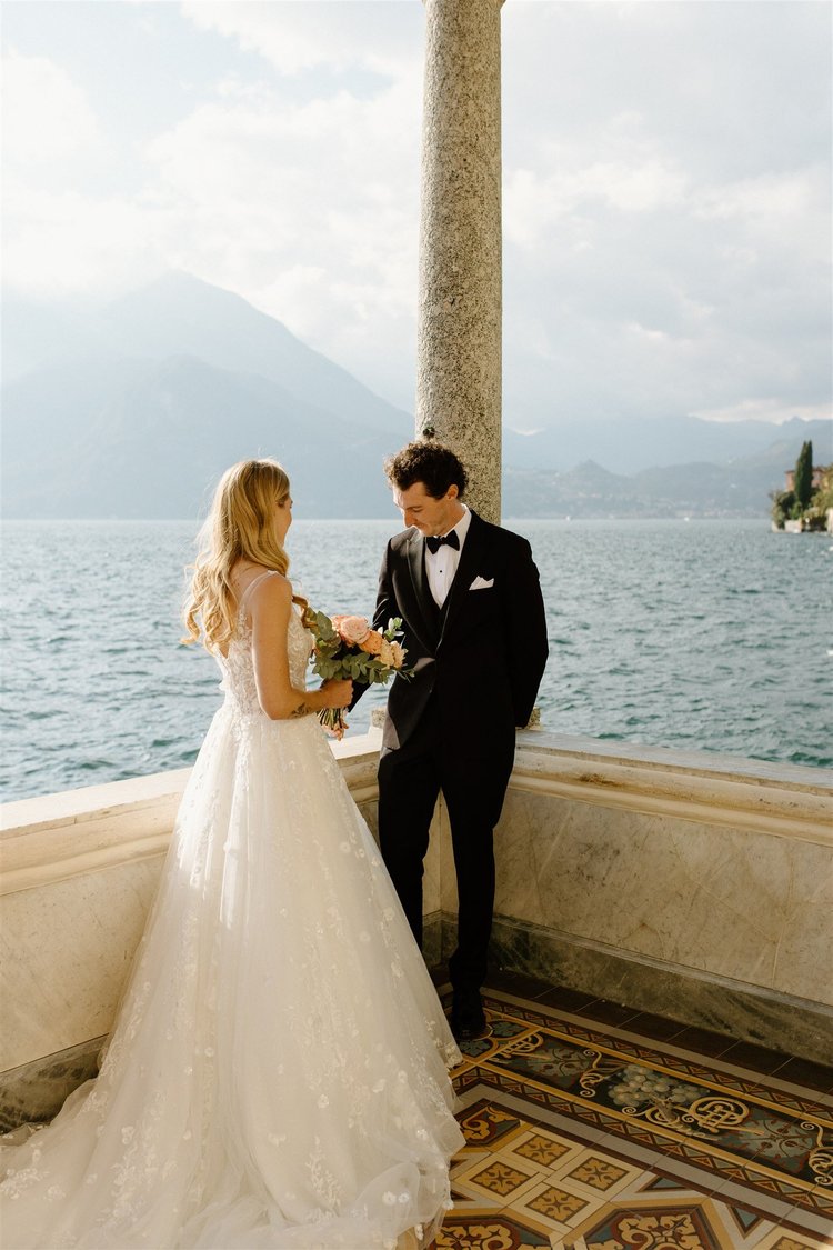 A couple on the loggia of Villa Monastero, above the lake