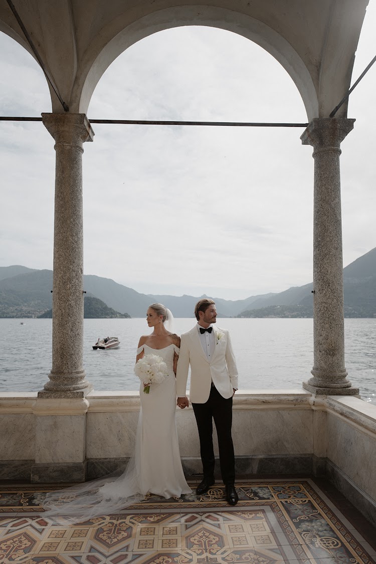 A couple on the balcony, looking out over the lake
