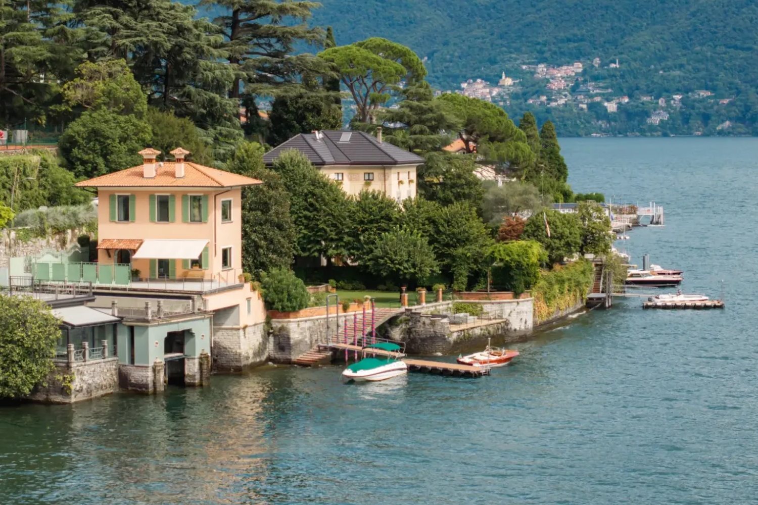 The pastel villa and its dock on the shore of Lake Como at Villa Noseda