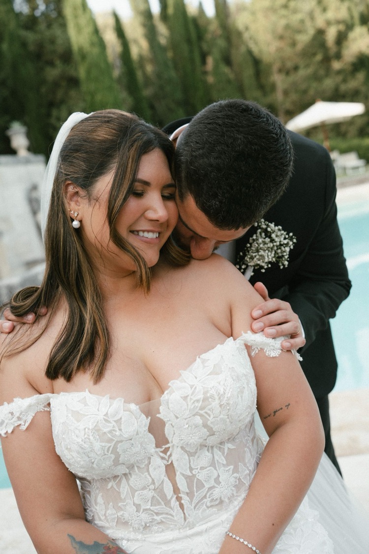 A close portrait of a bride and groom embracing beside the pool at Villa Poggiano, Tuscany
