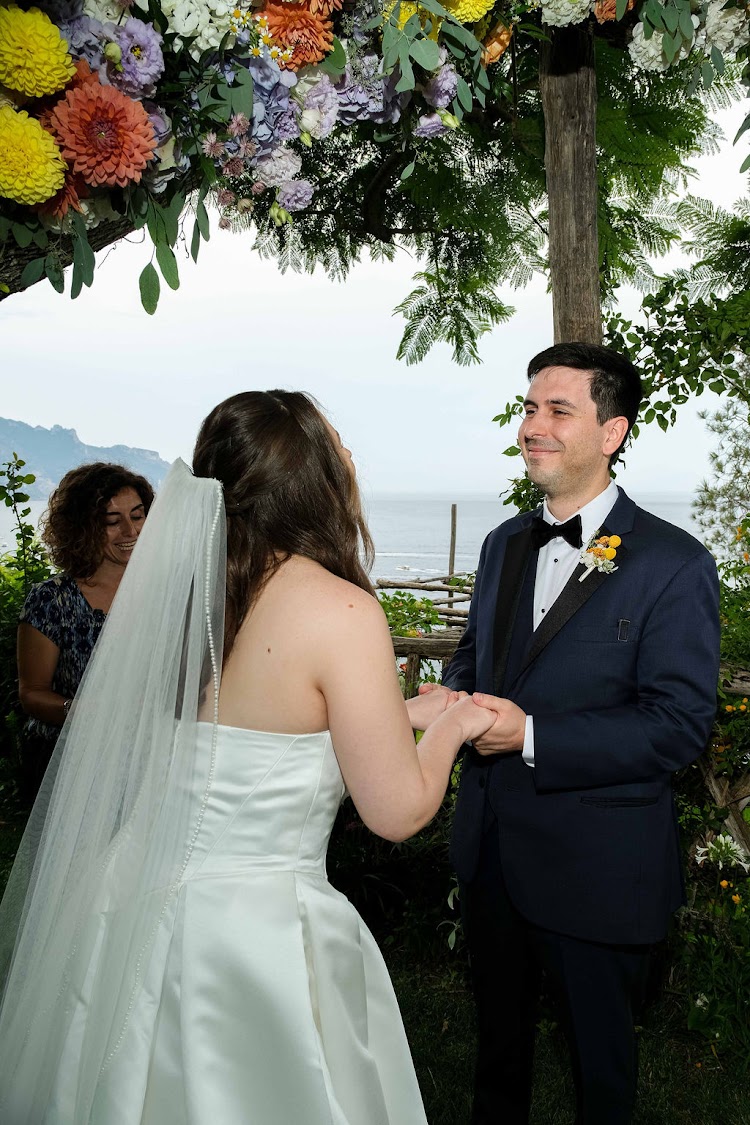 Couple holding hands during their elopement ceremony at Hotel Santa Caterina on the Amalfi Coast