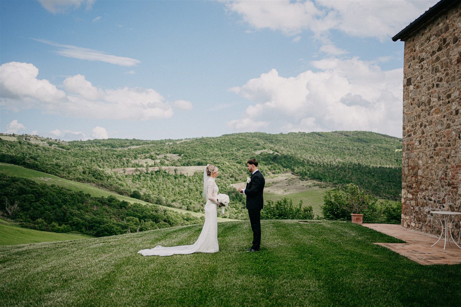 A couple on the lawn beside the farmhouse